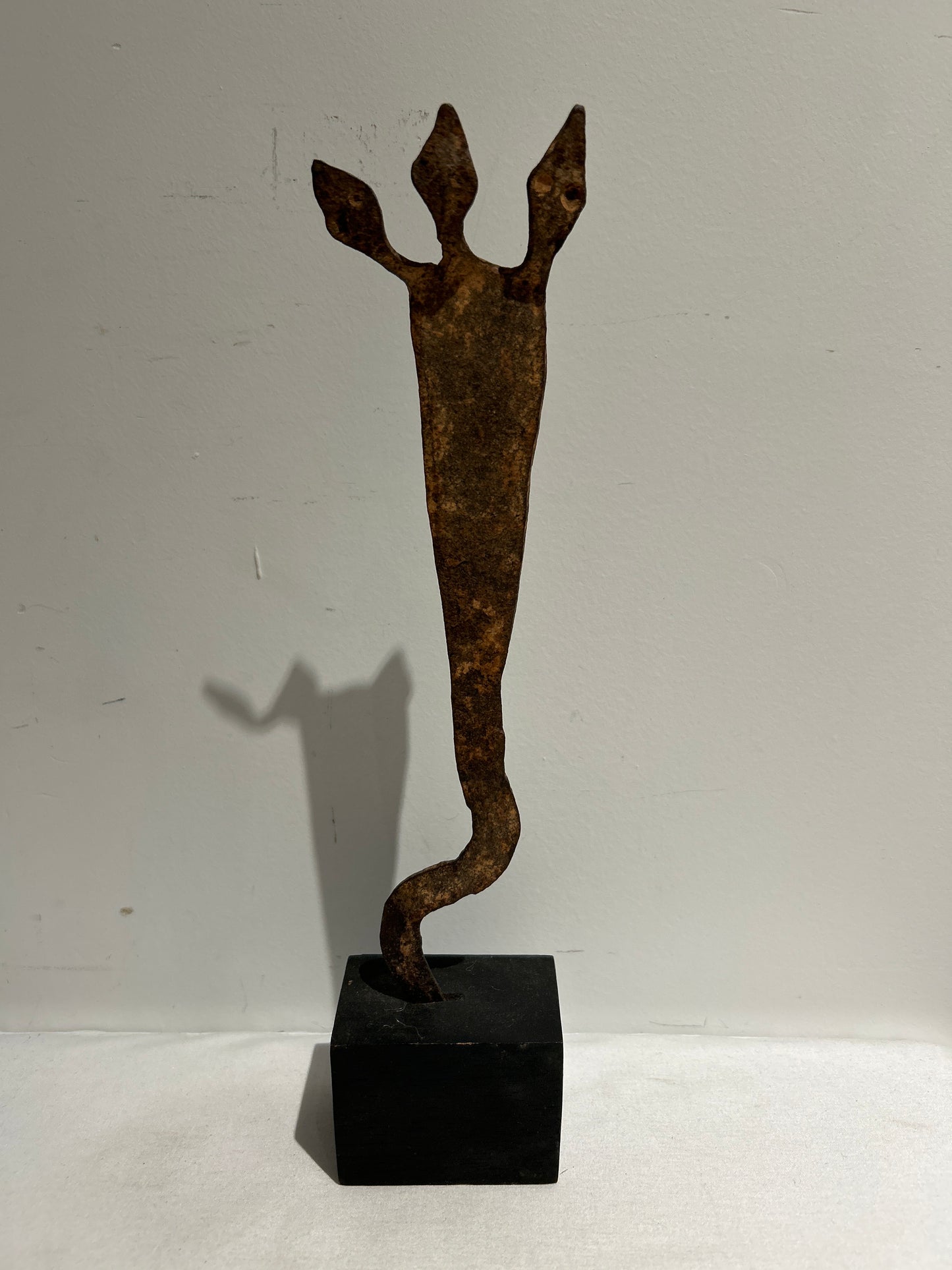 Metal sculpture on wood base