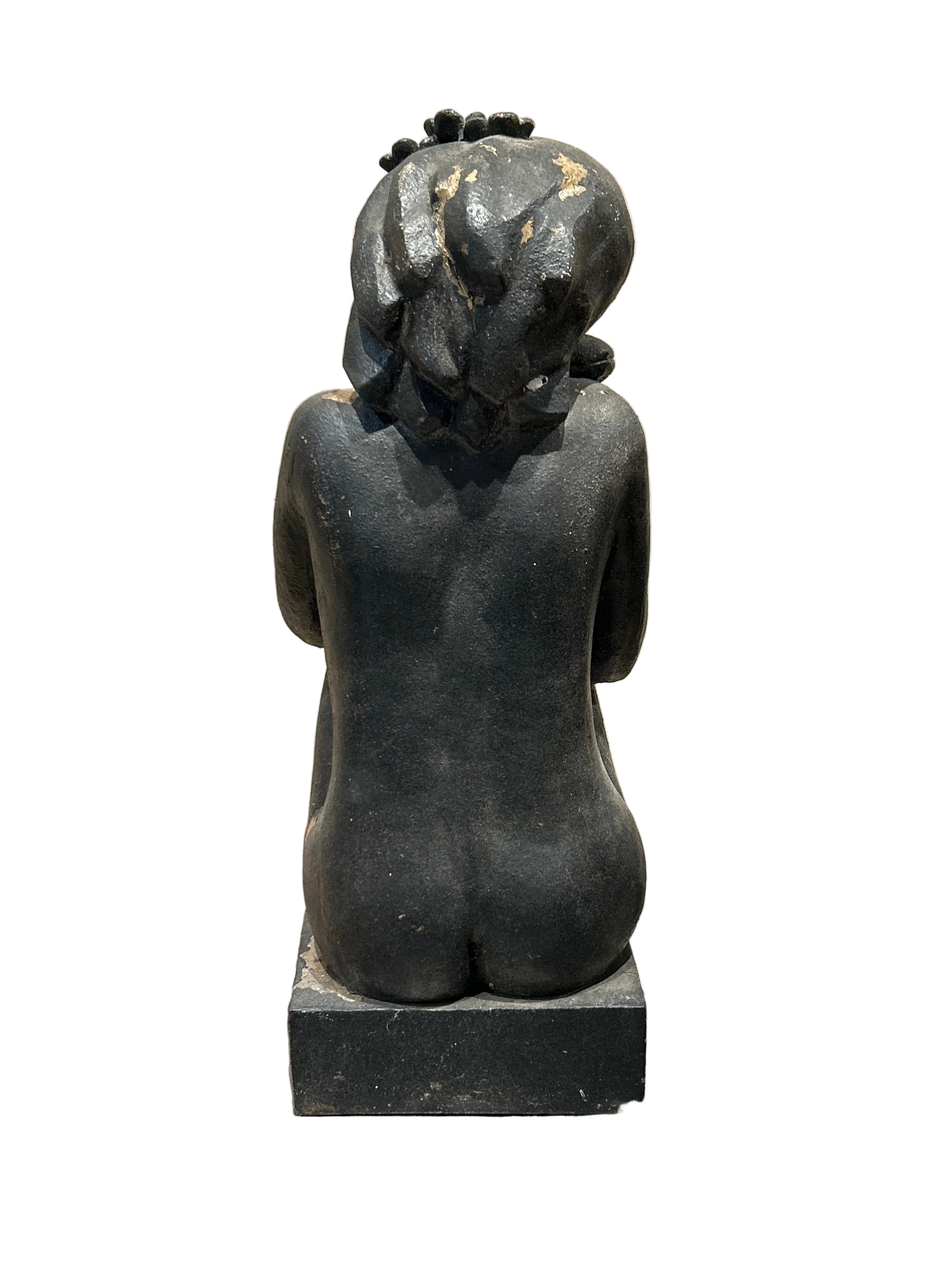 Vintage sitting woman statue with flowers in hair