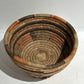 Woven basket with narrow base