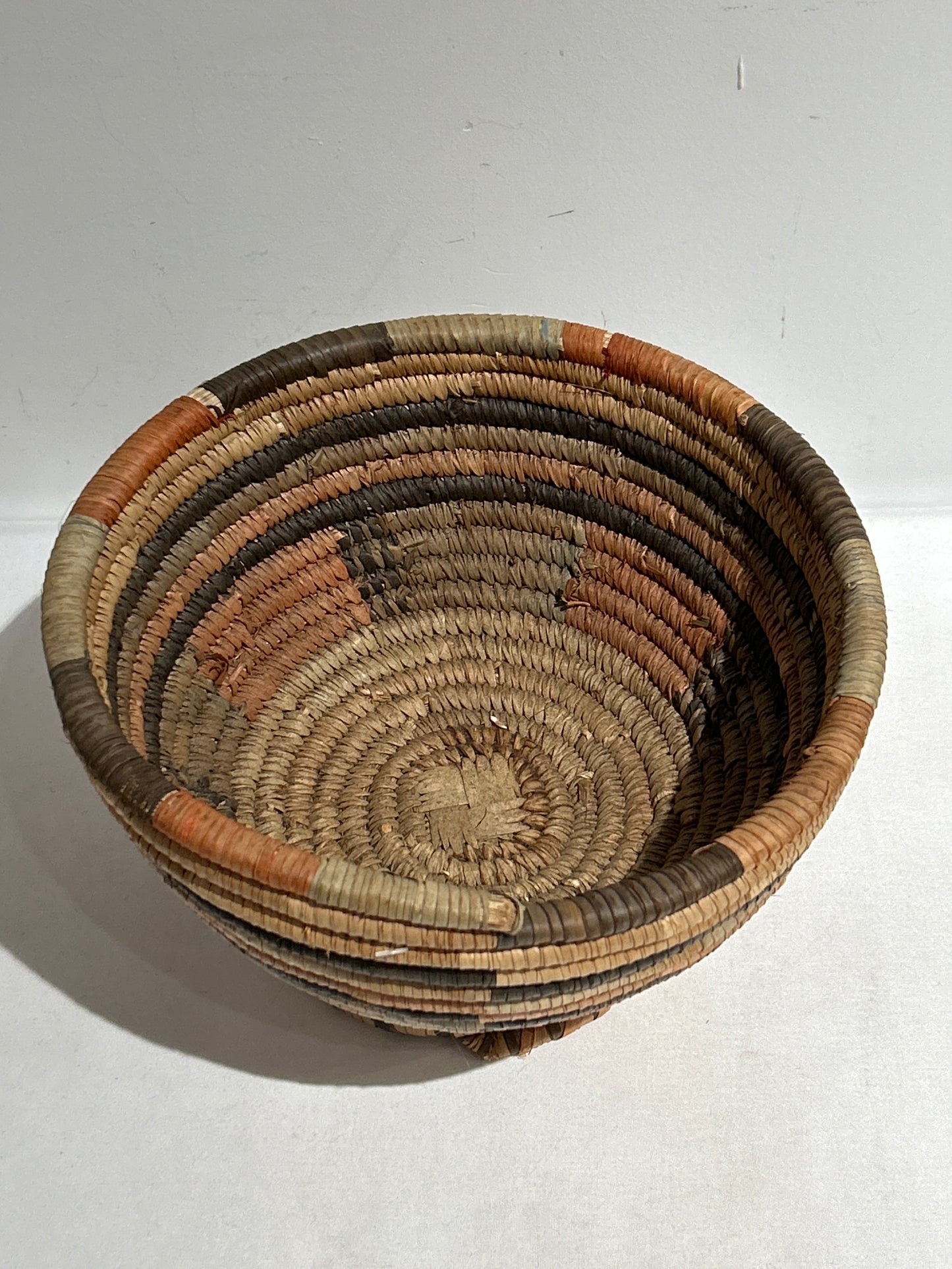 Woven basket with narrow base