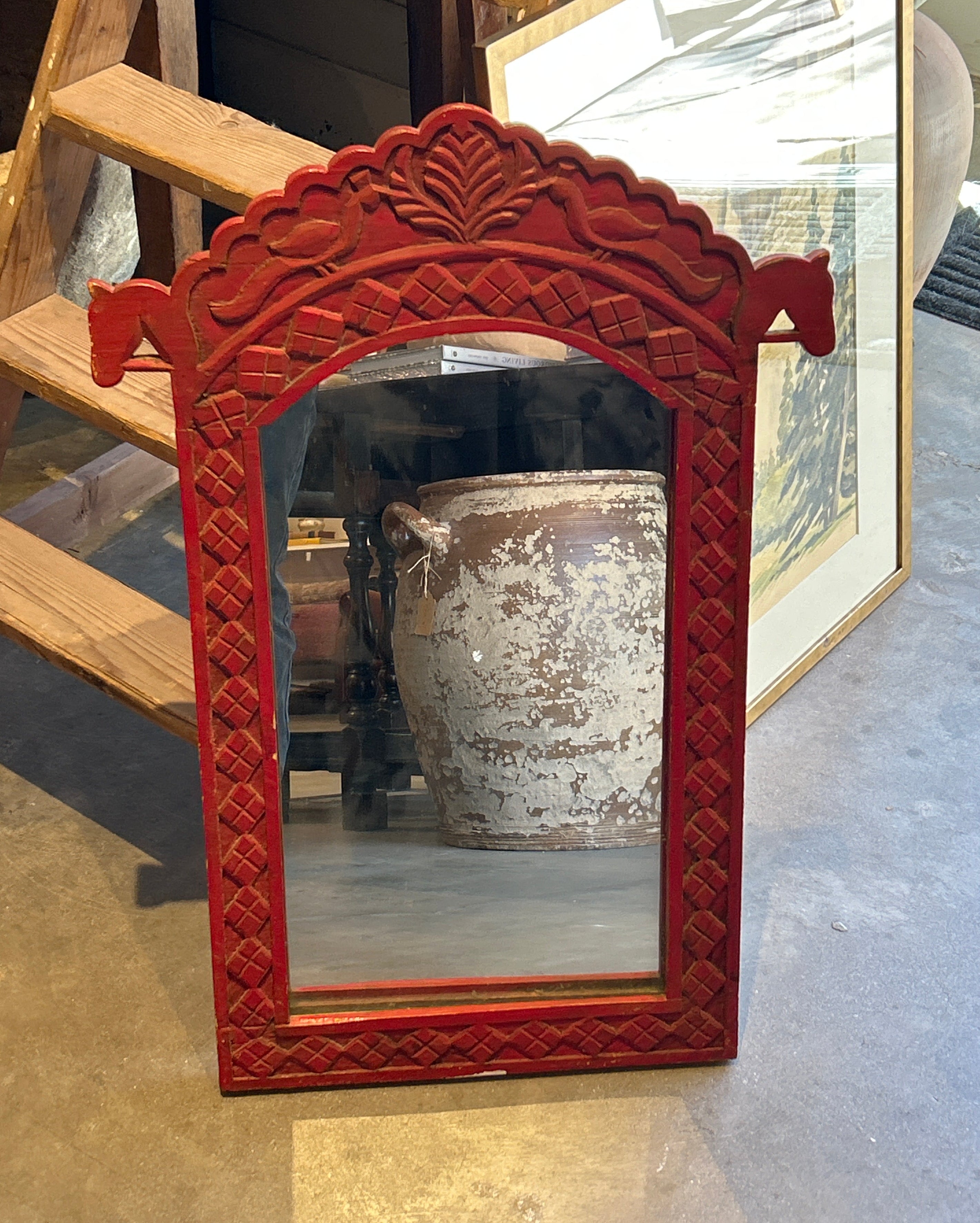 Vintage red wooden mirror with carved horse frame