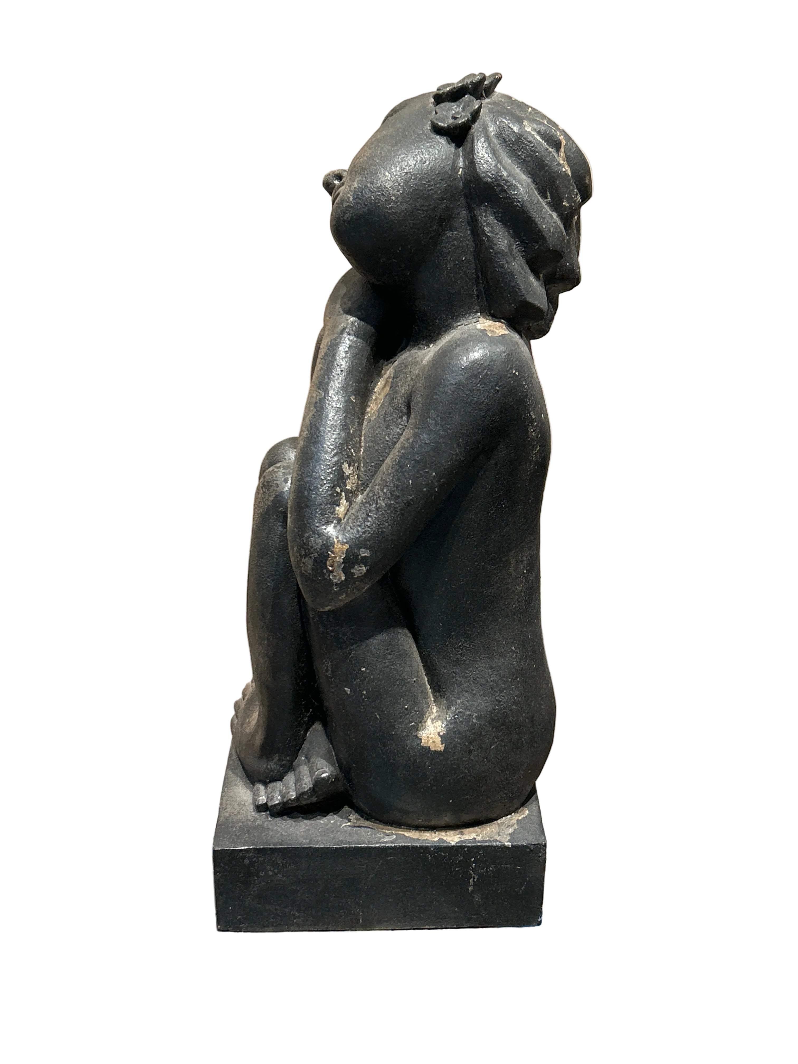 Vintage sitting woman statue with flowers in hair
