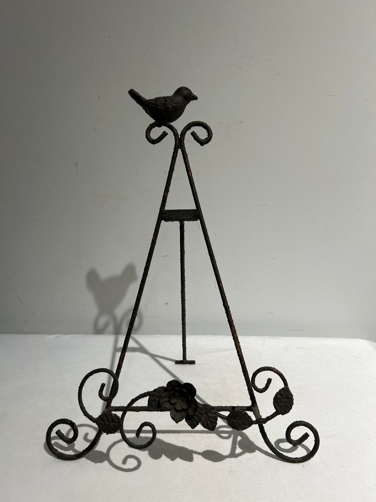 Metal easel with bird