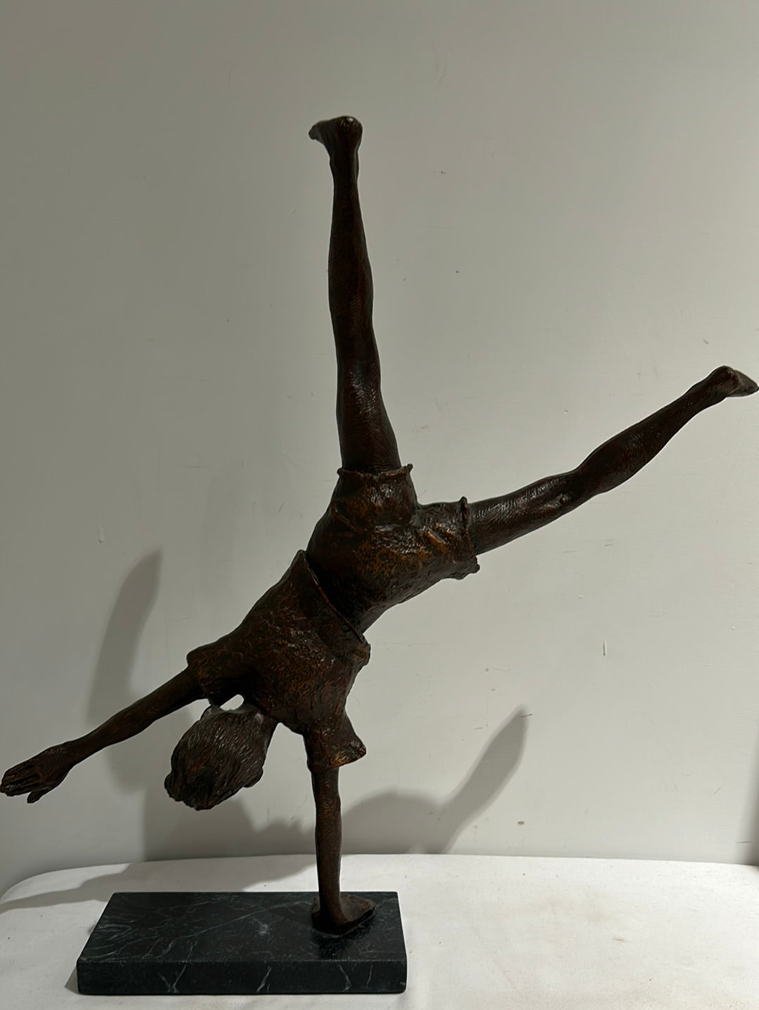 Vintage boy mid cartwheel statue