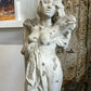 White concrete statue of woman