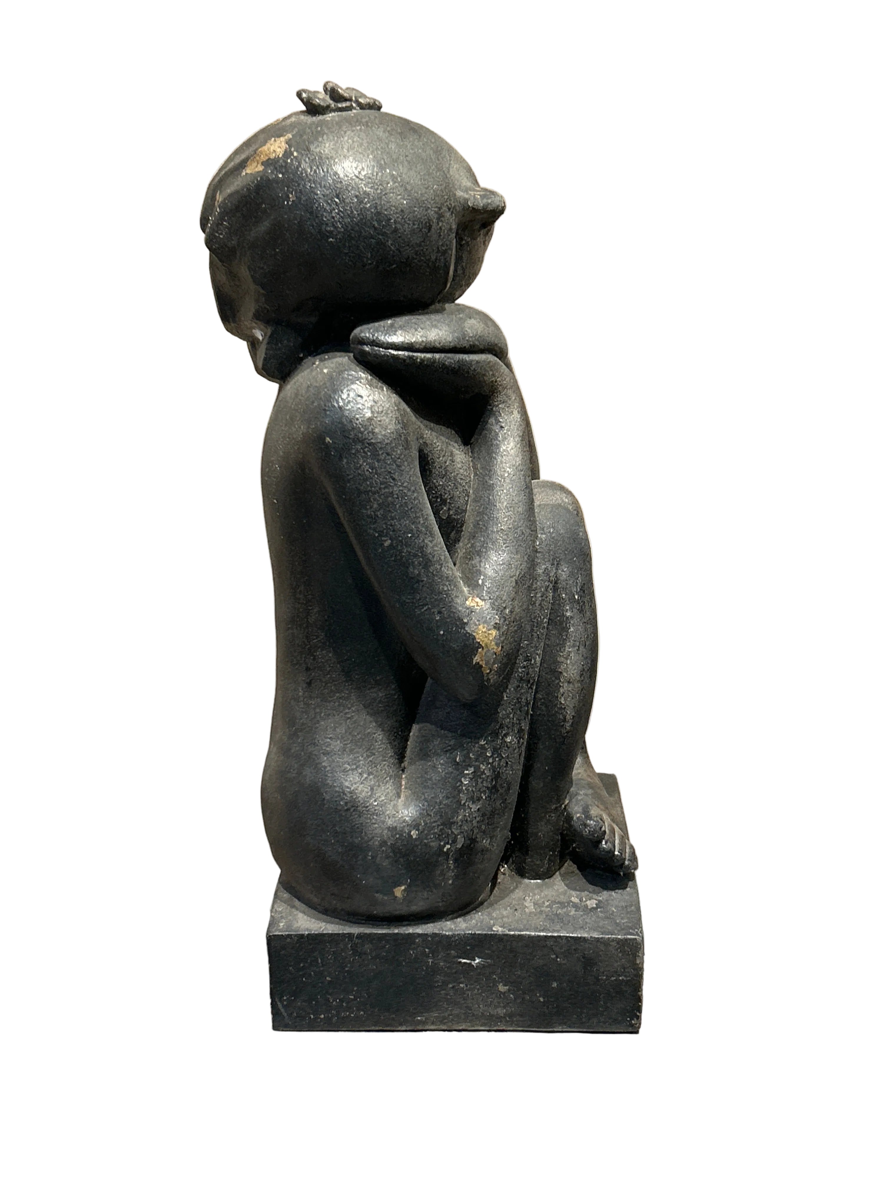 Vintage sitting woman statue with flowers in hair