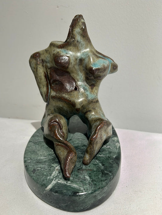 Vintage ceramic female sculpture on marble