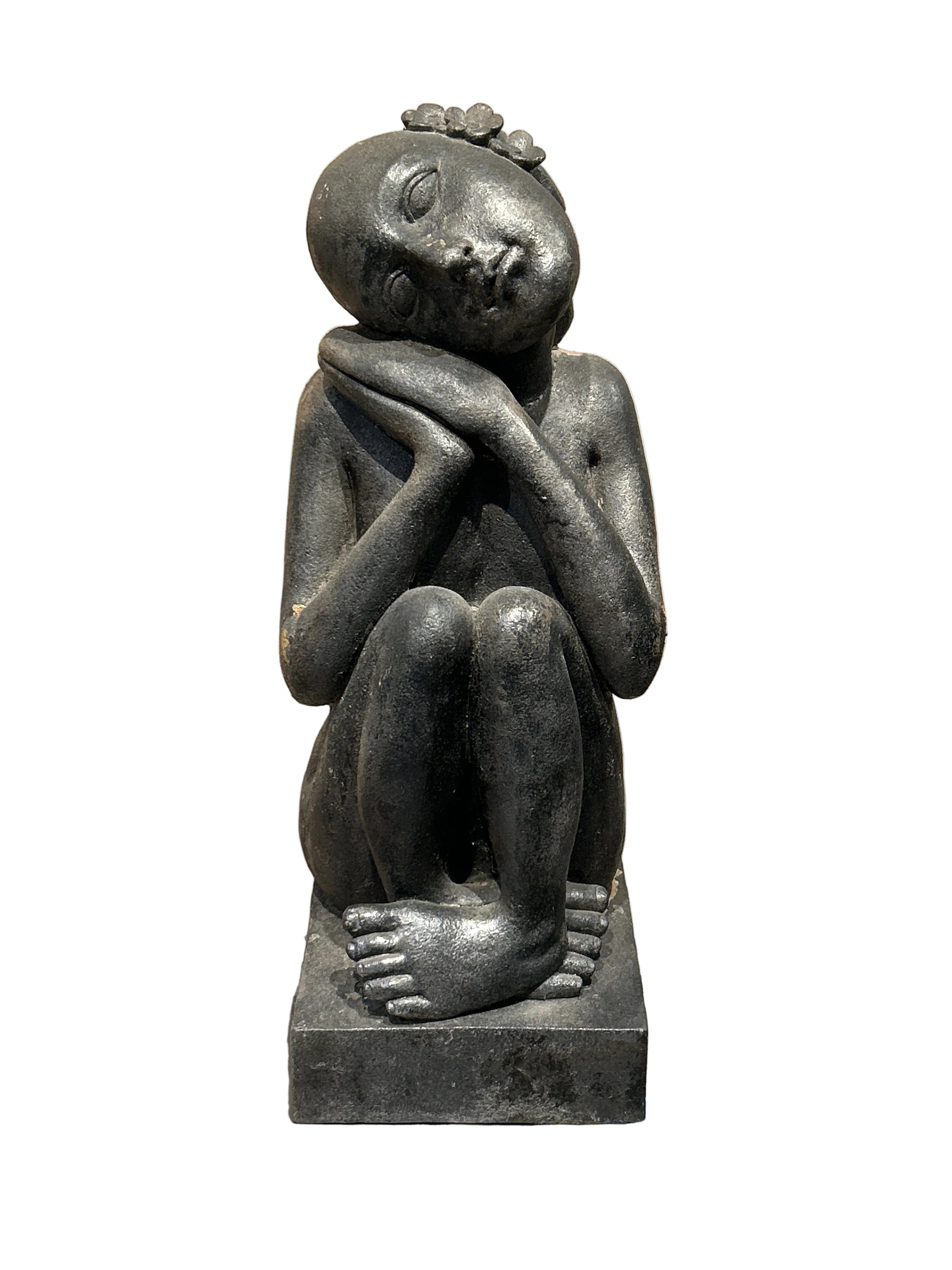 Vintage sitting woman statue with flowers in hair