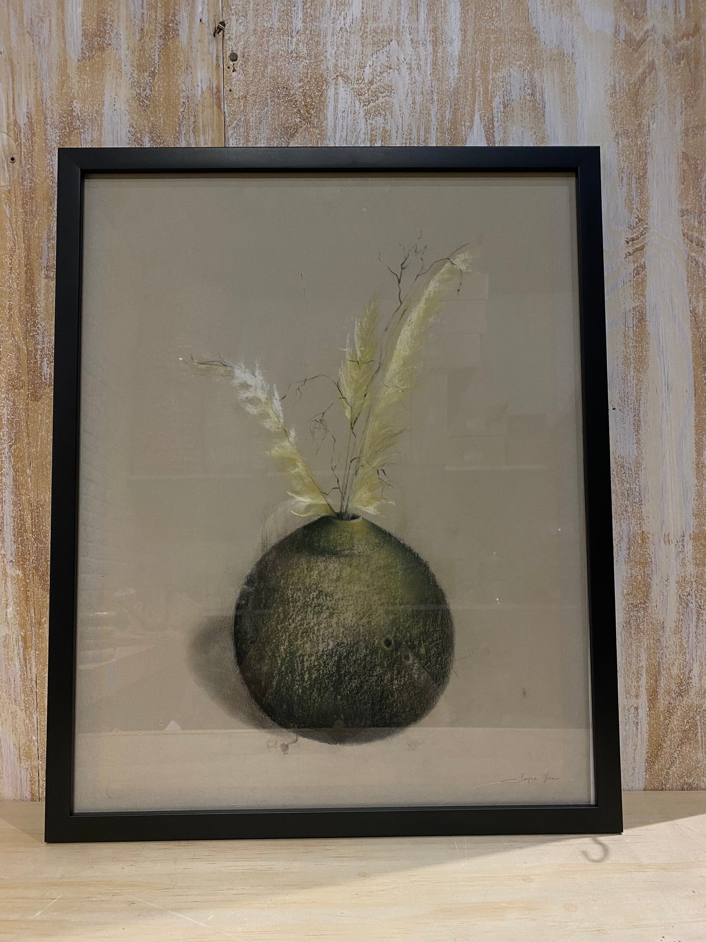 Framed drawing of vase with feathers