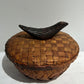 Woven lidded basket with wood bird