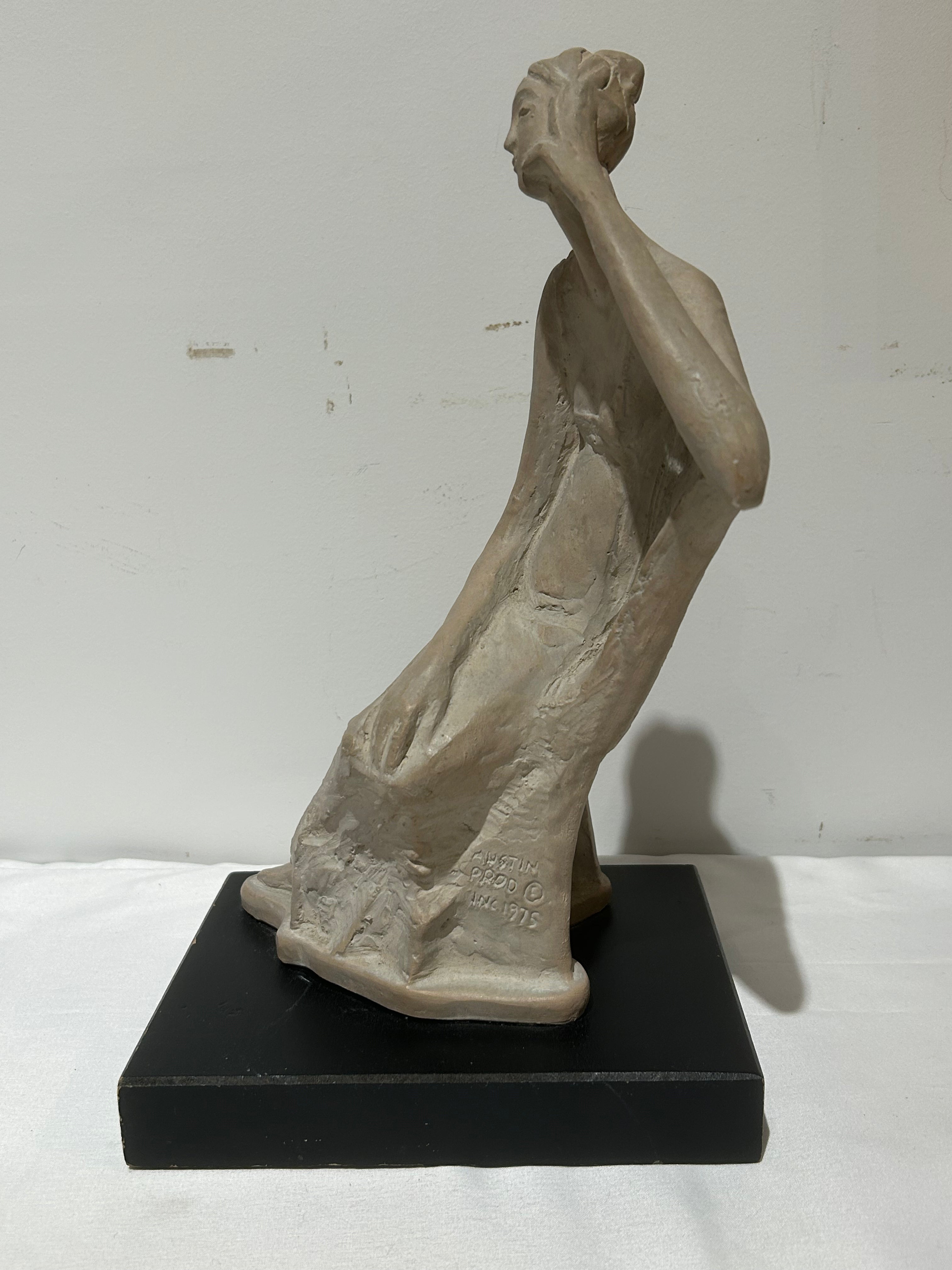 Vintage sitting figural sculpture on wood