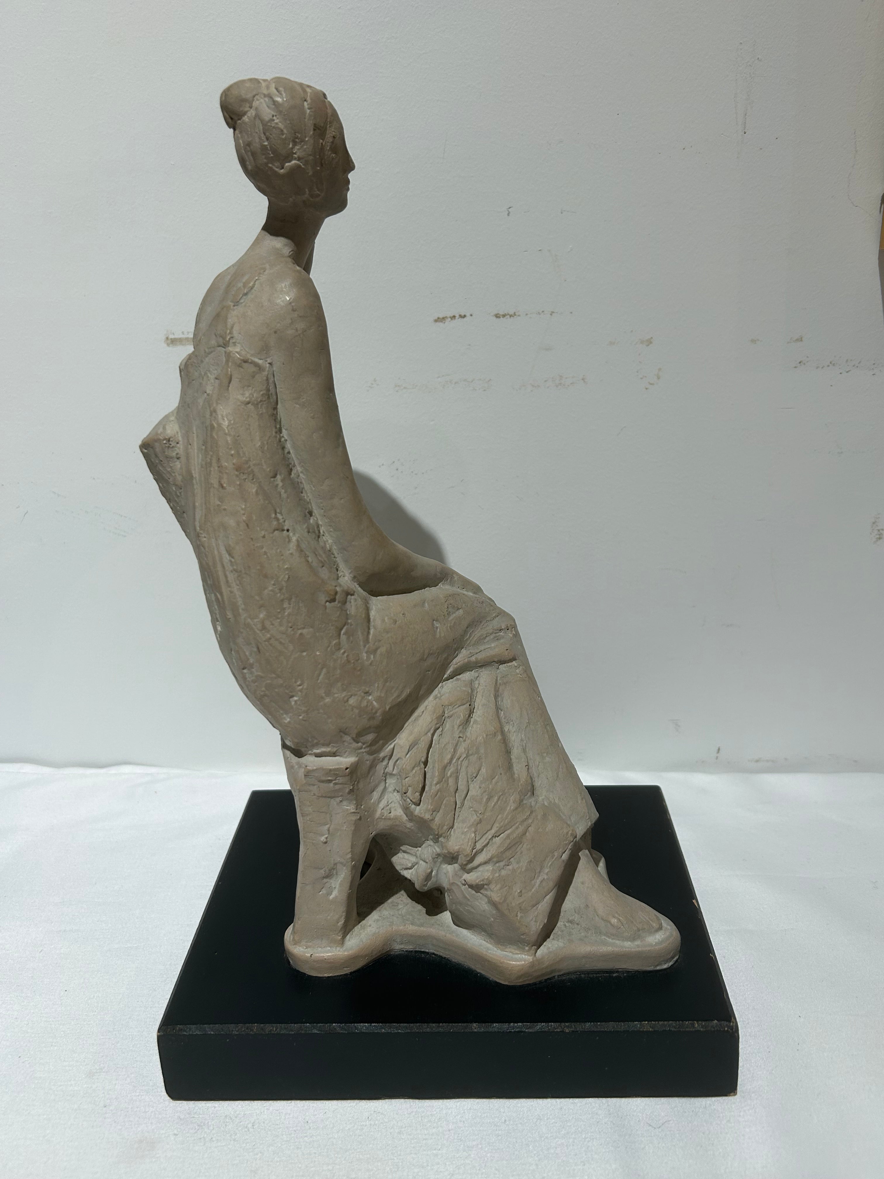 Vintage sitting figural sculpture on wood
