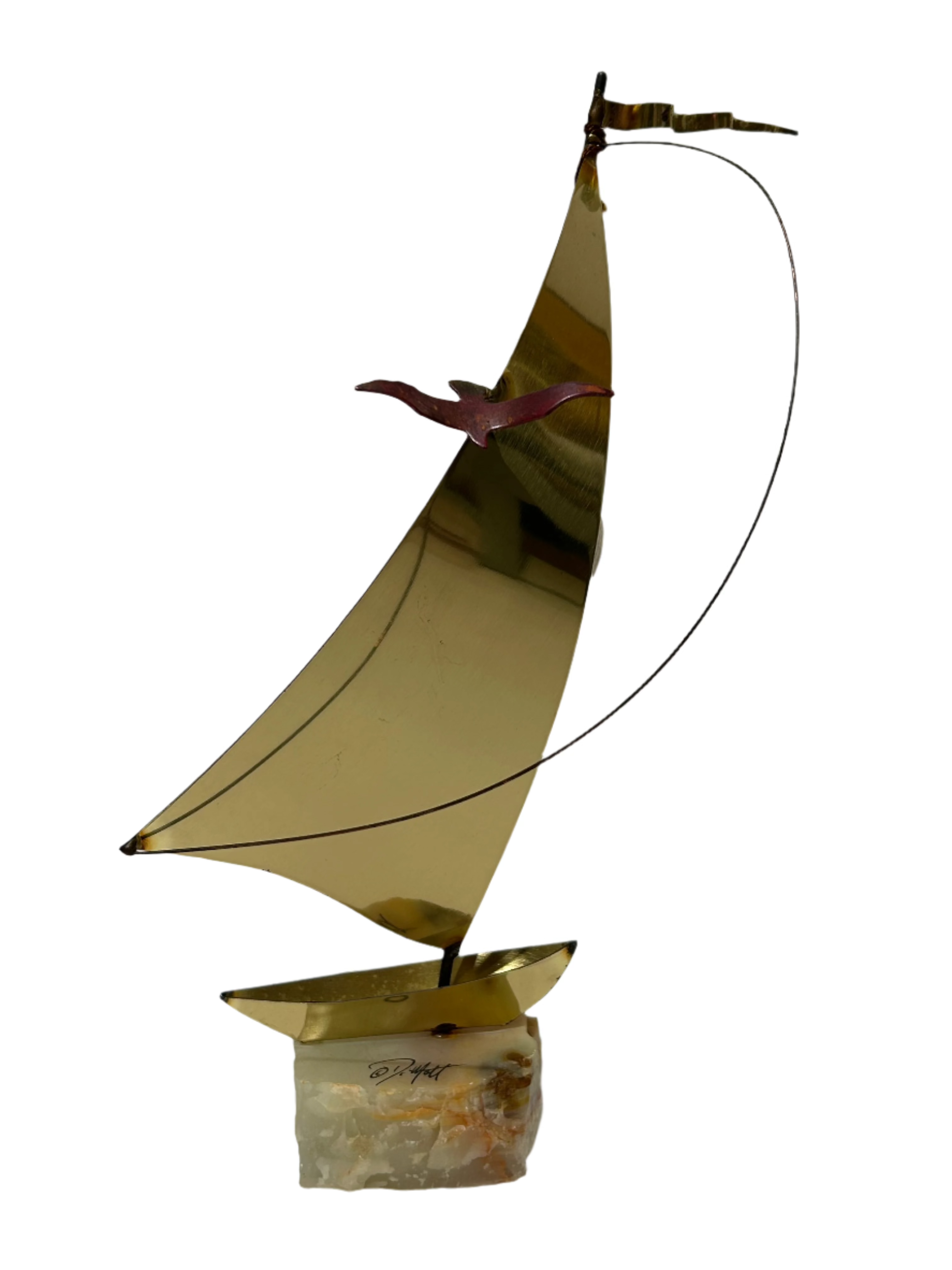 Vintage brass sailboat statue on stone