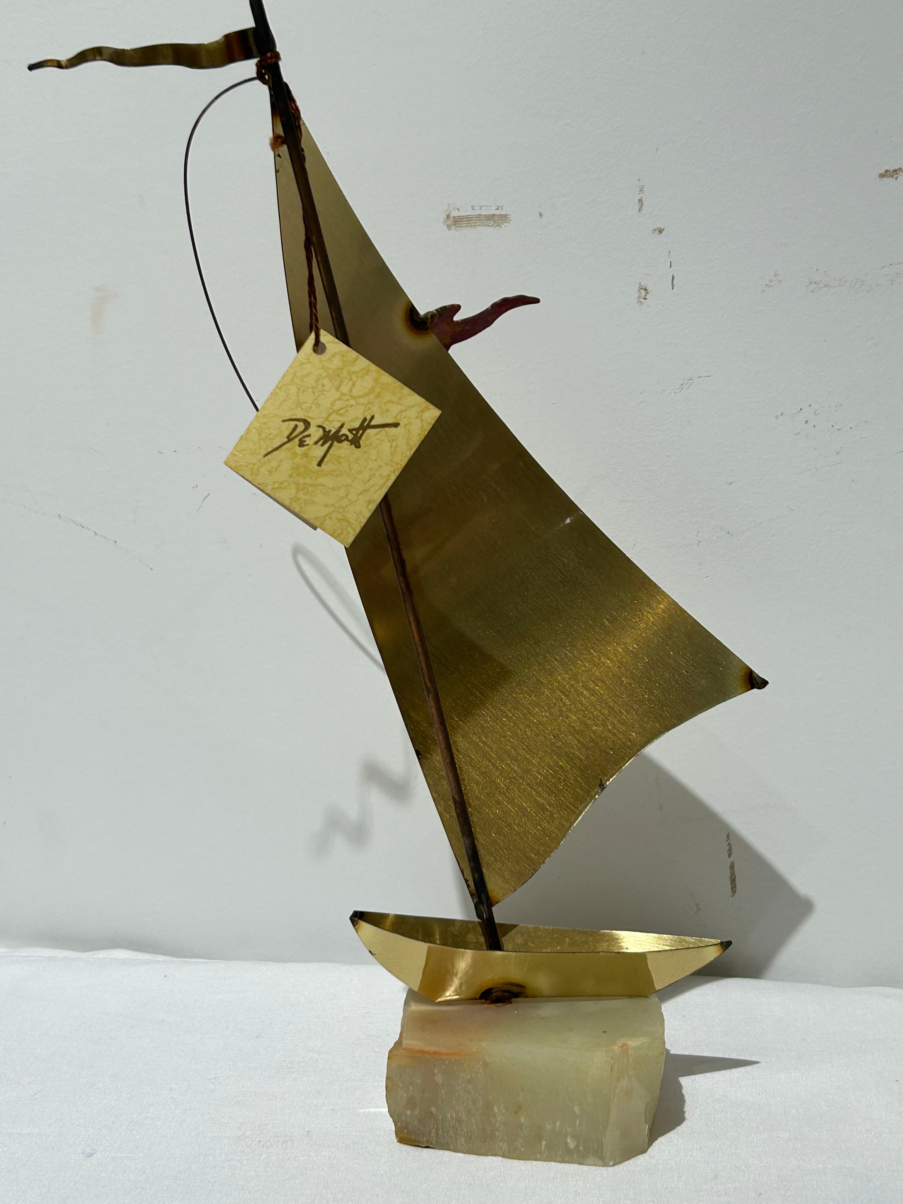 Vintage brass sailboat statue on stone