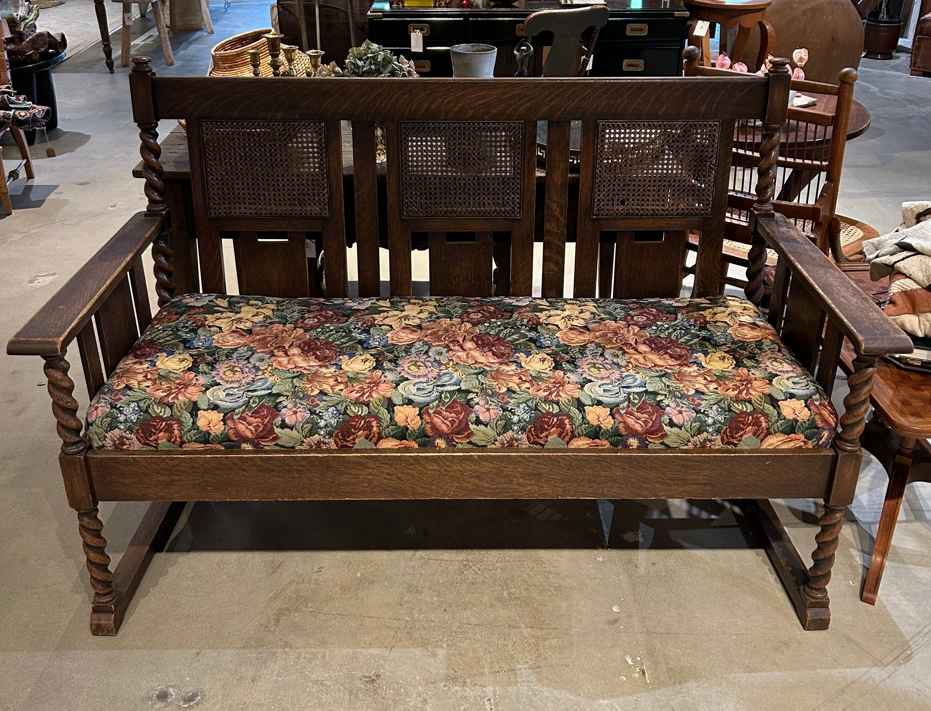 Vintage upholstered bench with cane back