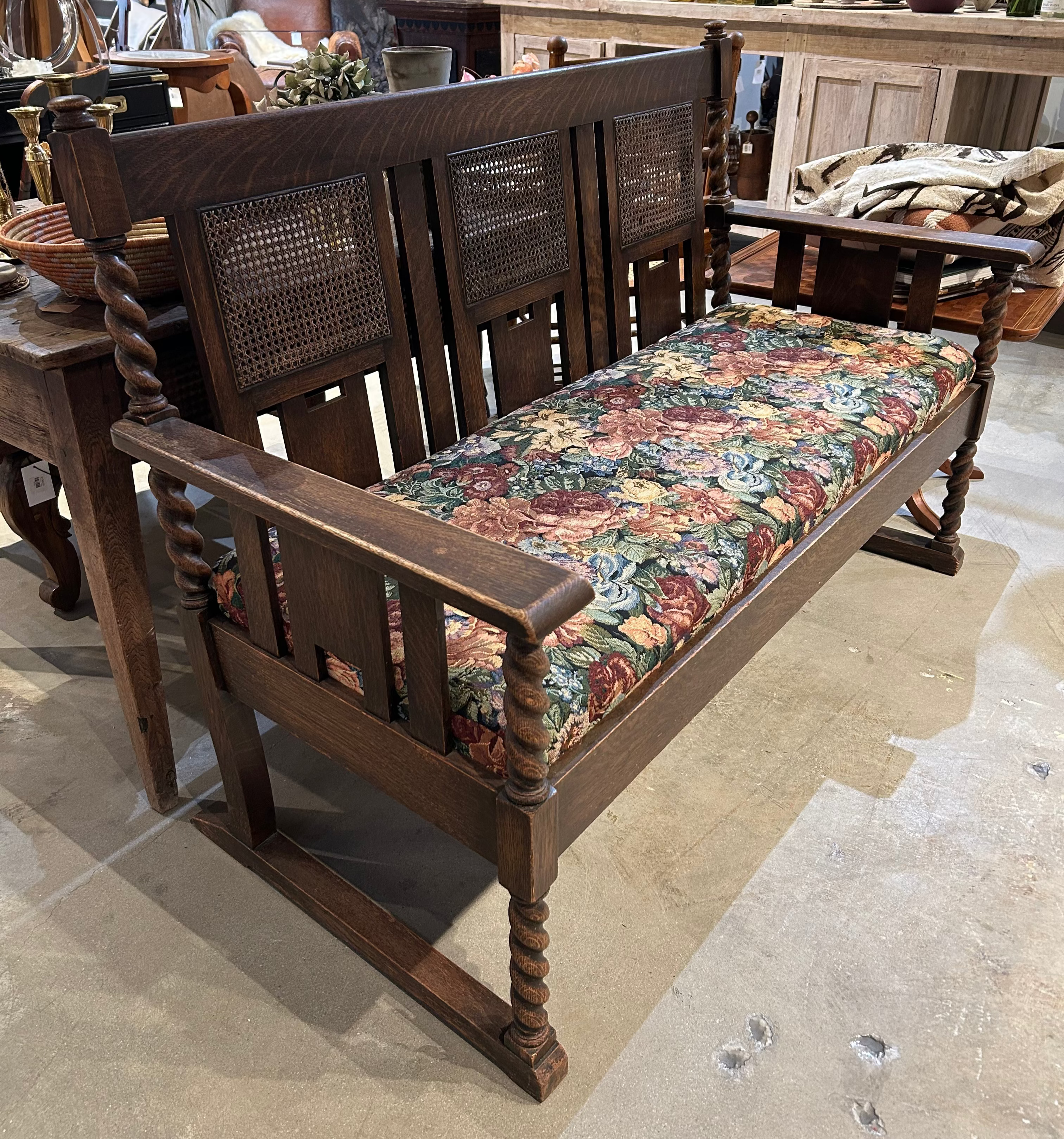 Vintage upholstered bench with cane back