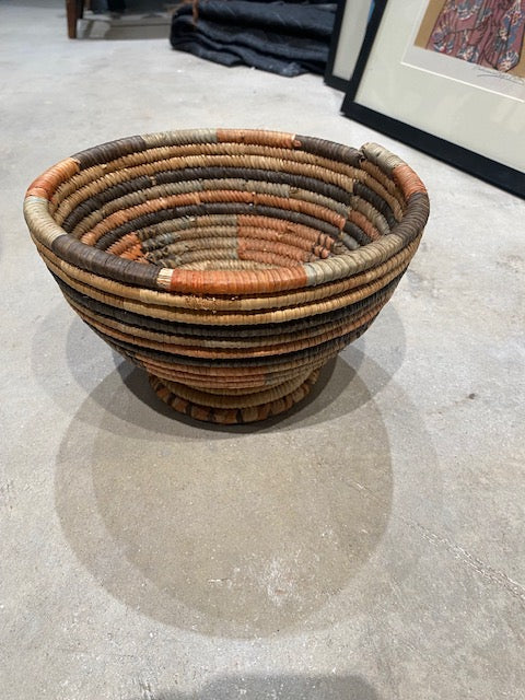 Woven basket with narrow base