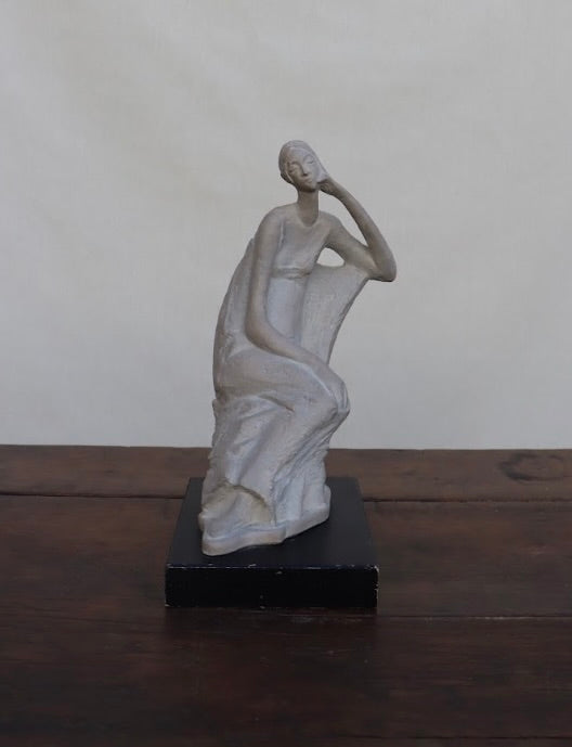 Vintage sitting figural sculpture on wood